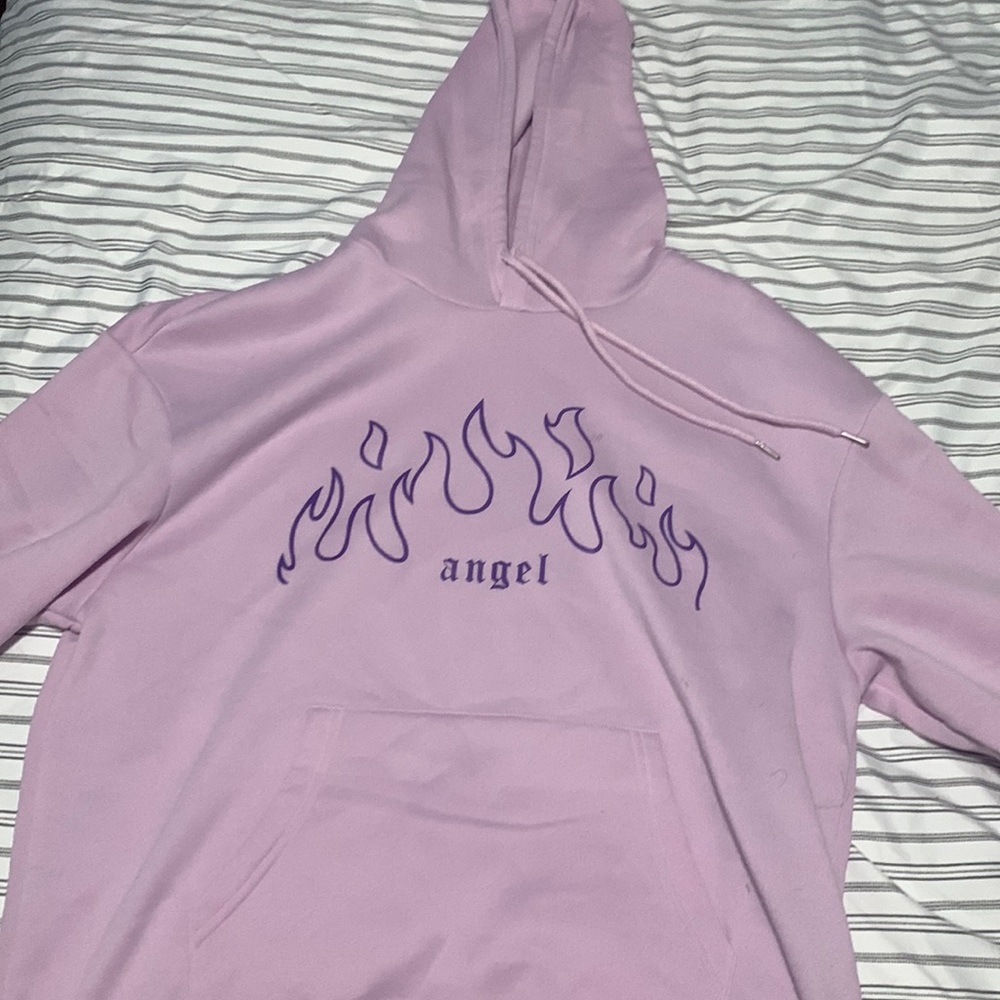 A purple long sleeve sweater with design size:L